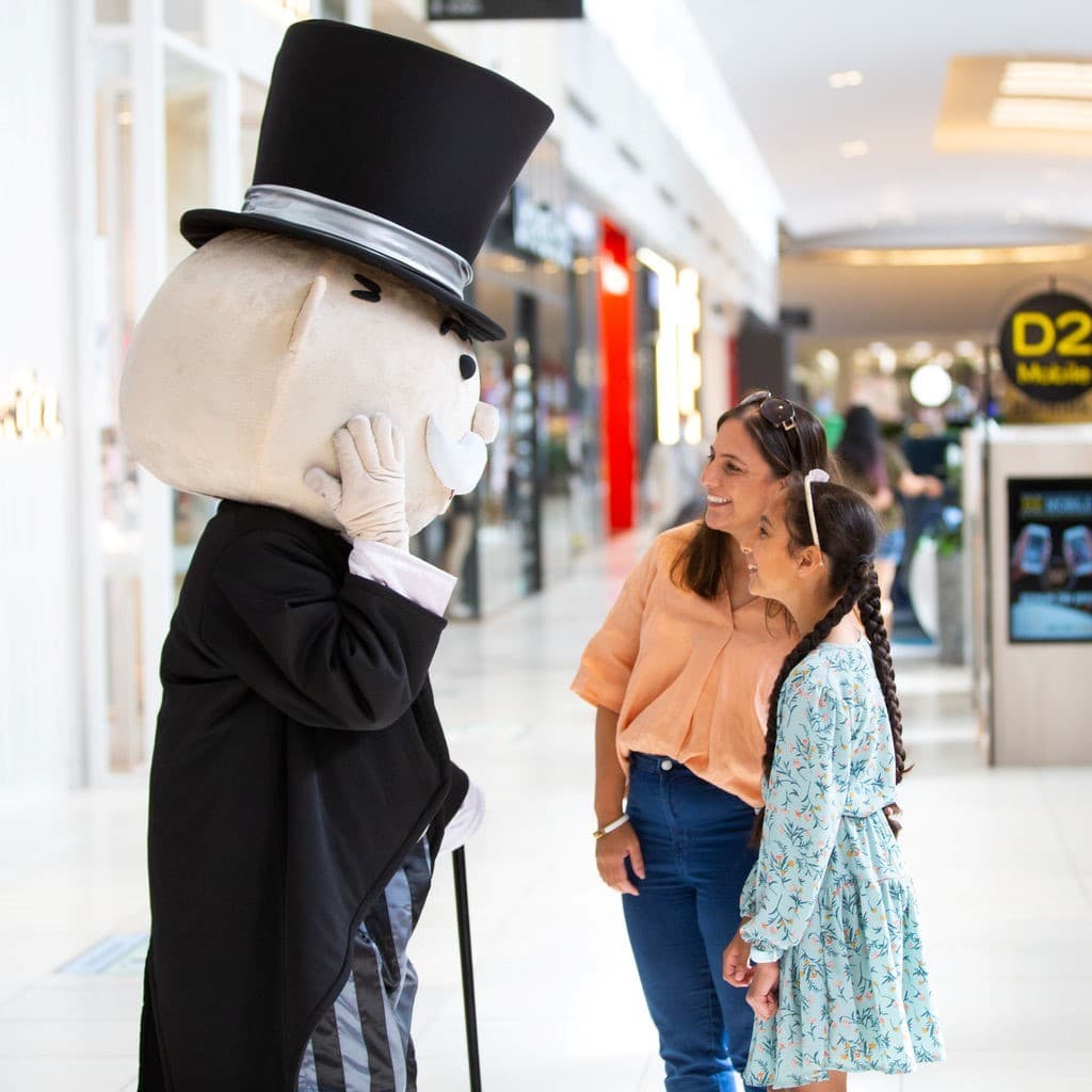 Mr Monopoly talking with two customers