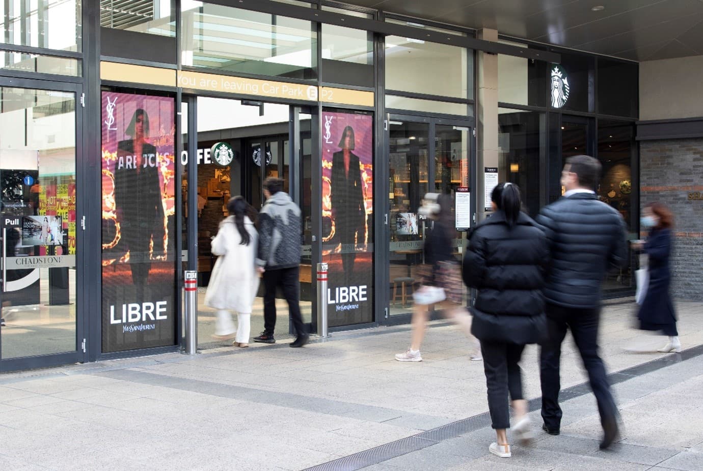Customer walk through doors with media screens 