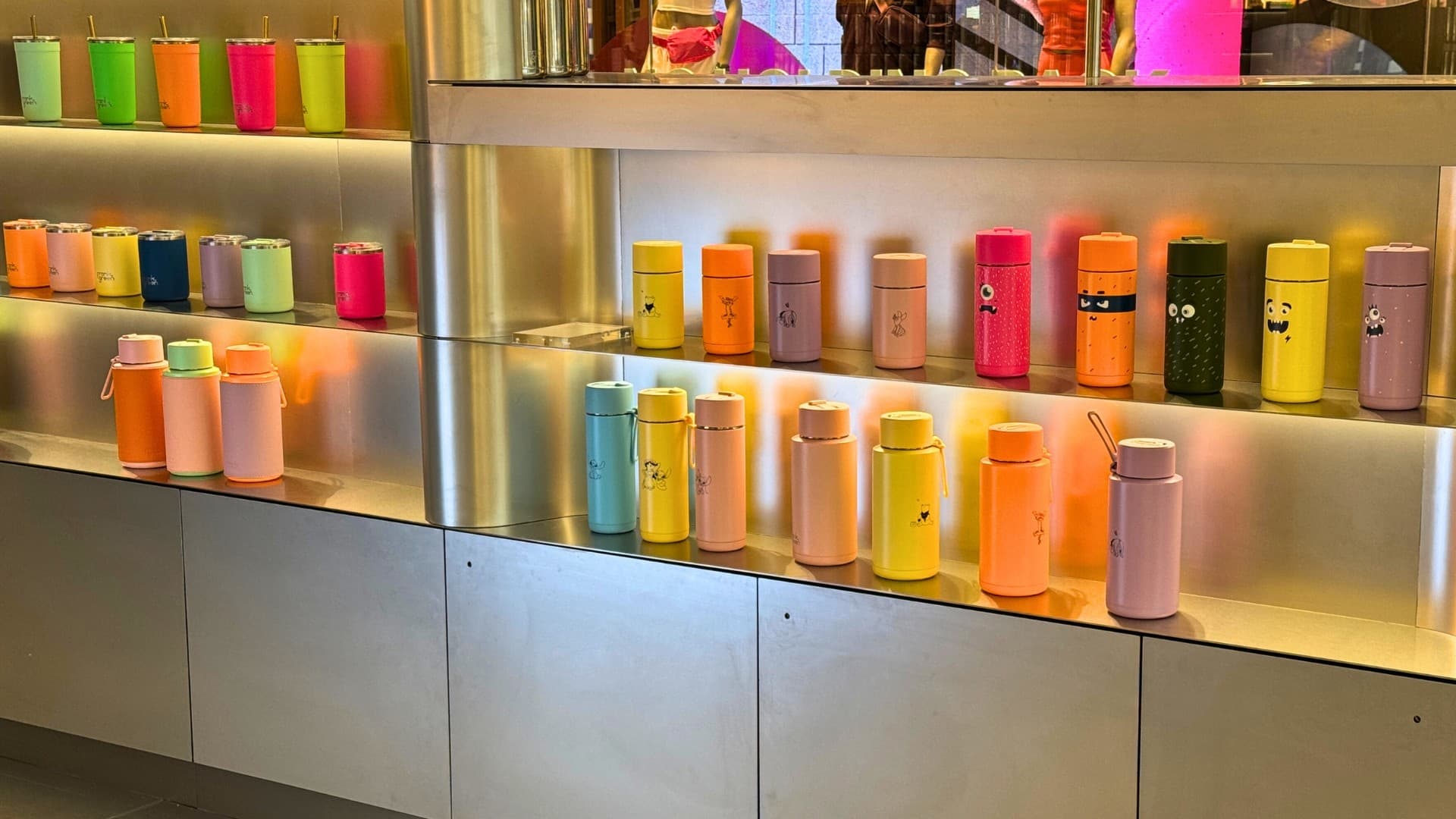 Colourful water bottle lined up on a store shelf