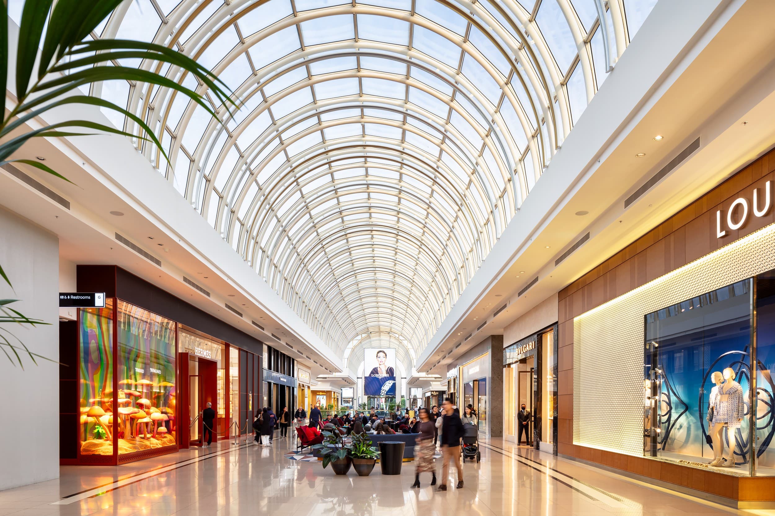 A glas roofed mall avenue with luxury brand stores