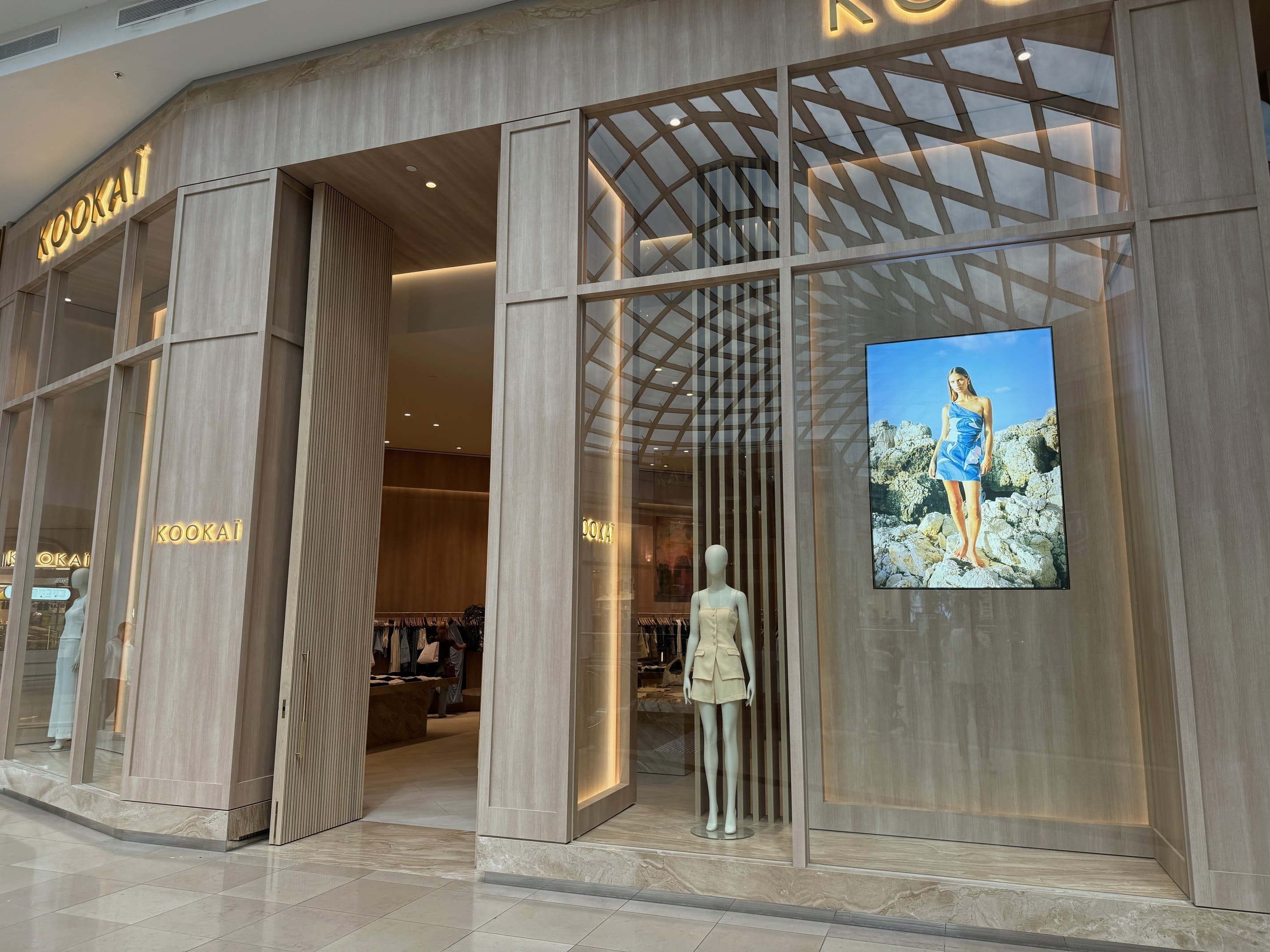 Large glass fronted retail store with a mannequin in the window