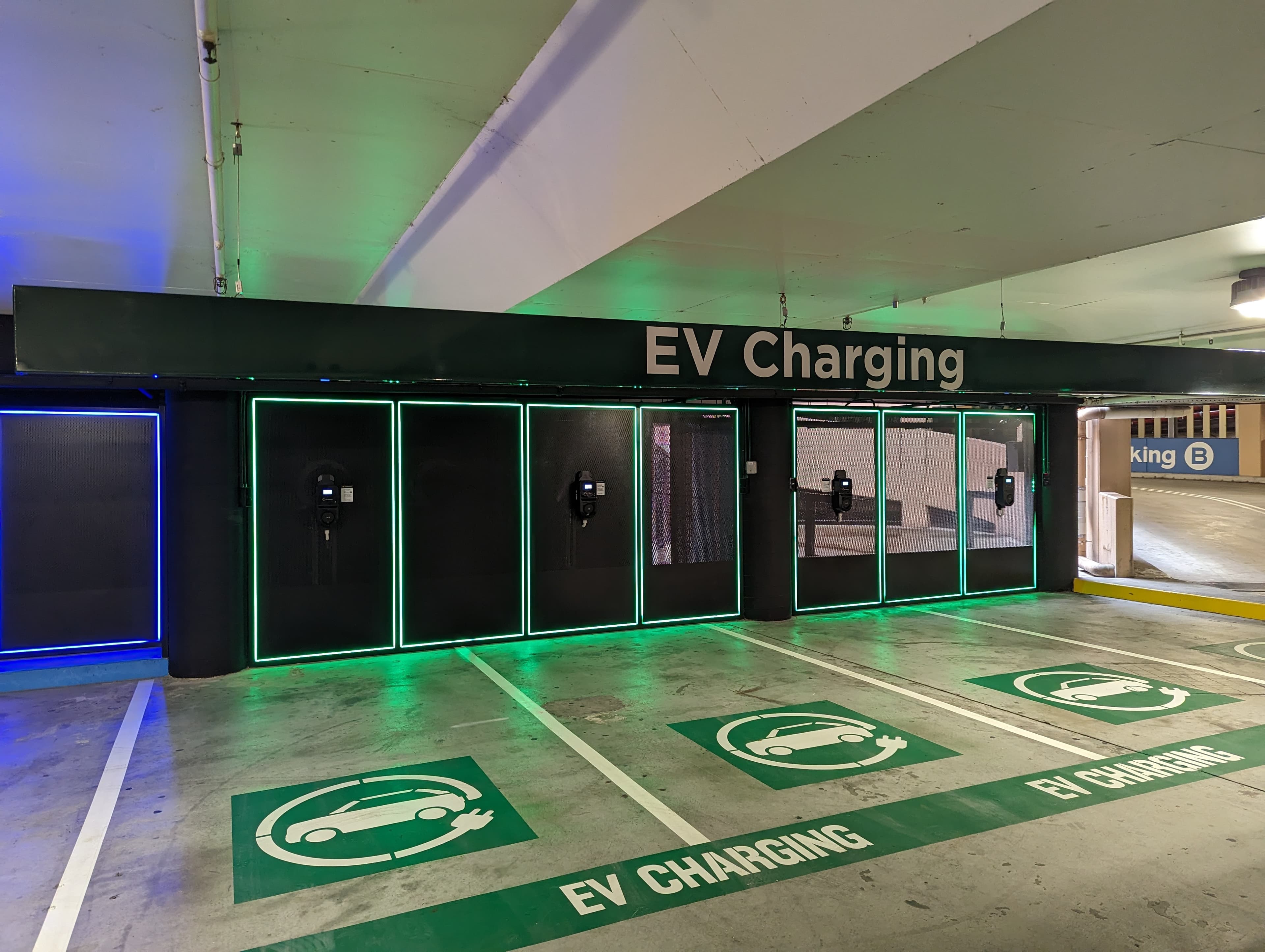 EV charging bays with green icons